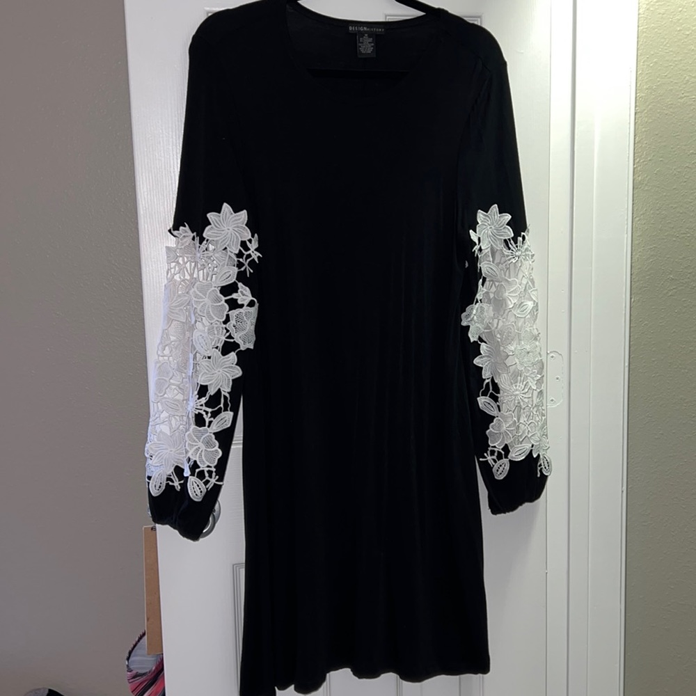 Women’s little black dress with white lace sleeves